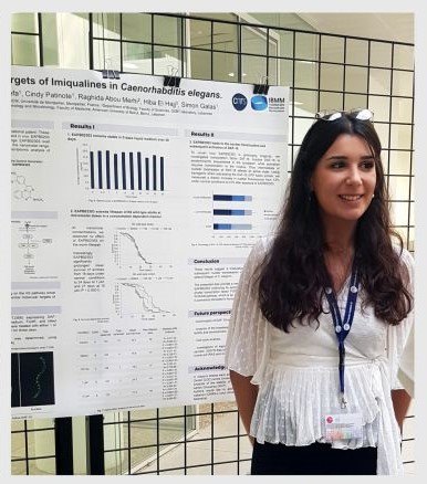Perla Makhoul in front of her poster at the IBMM in Montpellier