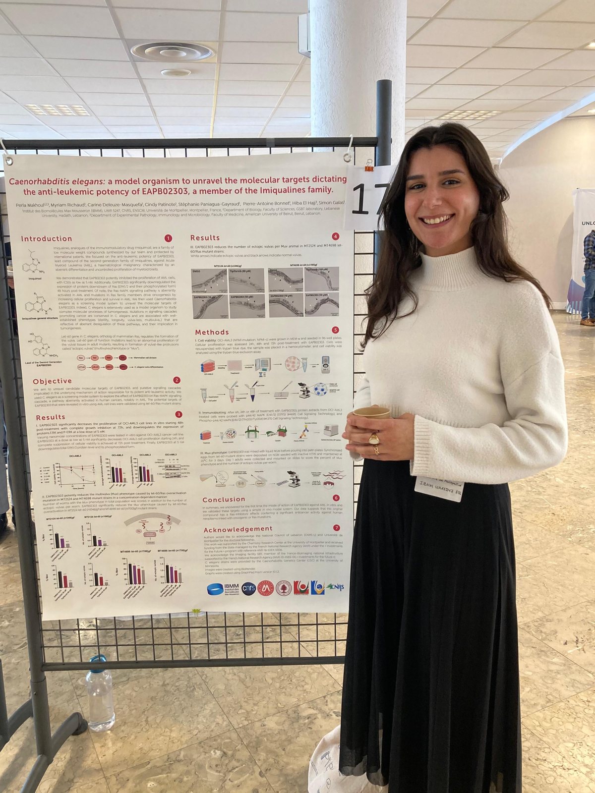 Perla Makhoul standing beside her poster at the Ver Midi XXV conference in Lyon